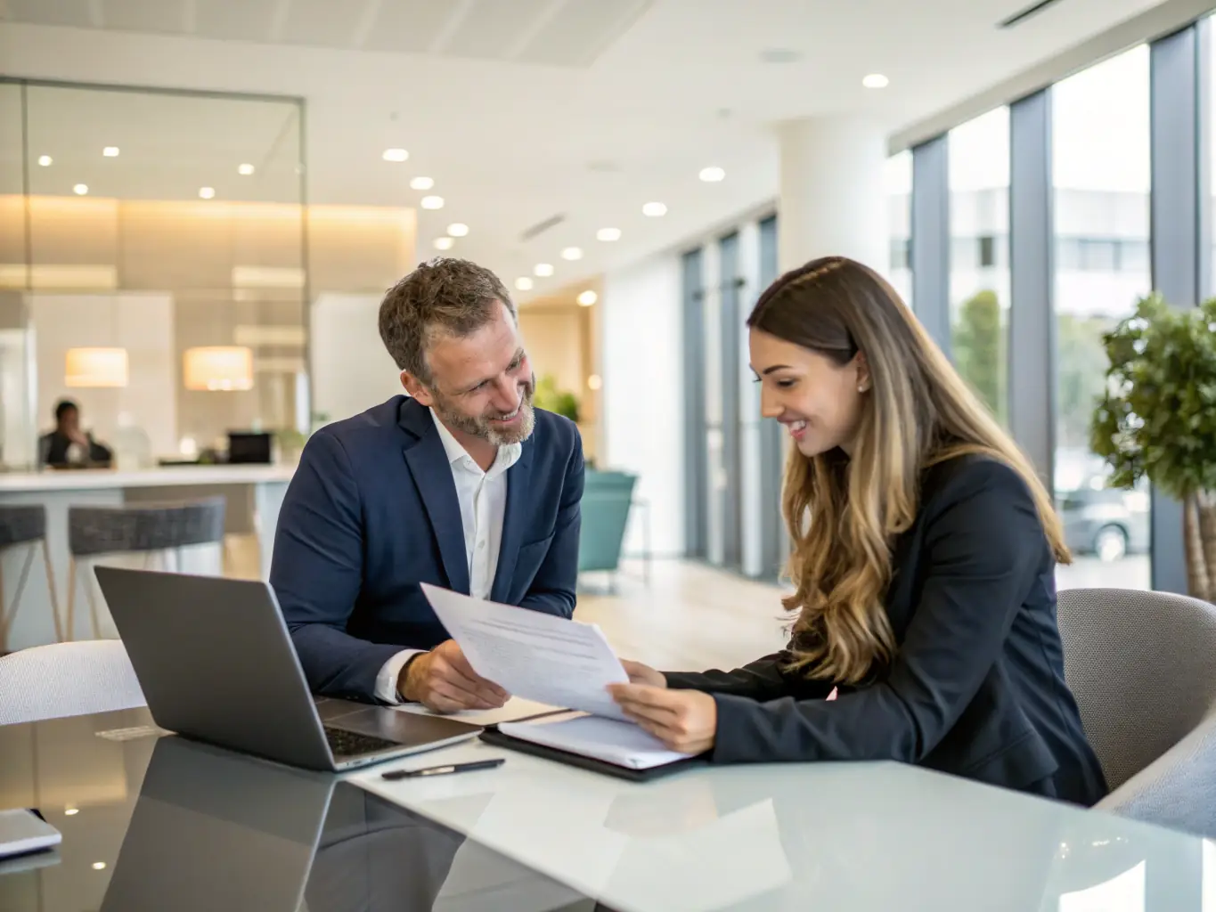 A professional photo of a modern office setting with staff assisting a client with paperwork related to car import documentation.